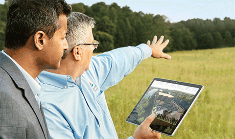 Engineers in filed with animated building